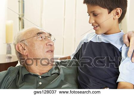 Close-up of a grandfather talking to his grandson View Large Photo Image Stock Photo - Close-up of a grandfather talking to his grandson. Fotosearch