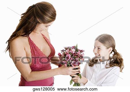 High angle view of a girl giving her mother a bunch of flowers View Large Photo Image Stock Photography - High angle view of a girl giving her mother a bunch of flowers. Fotosearch