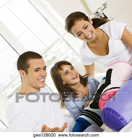 Parents and their daughter sitting on the bed View Large Photo Image Stock Image - Parents and their daughter sitting on the bed. Fotosearch