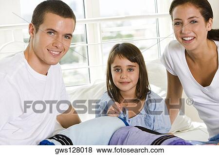 Parents and their daughter smiling View Large Photo Image Stock Photo - Parents and their daughter smiling. Fotosearch