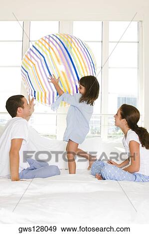 Stock Photo - Parents playing with their daughter. Fotosearch