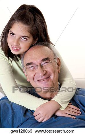 Portrait of a granddaughter hugging her grandfather from behind View Large Photo Image Stock Image - Portrait of a granddaughter hugging her grandfather from behind. Fotosearch