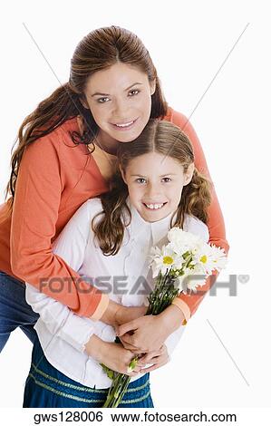 Portrait of a mother hugging her daughter from behind View Large Photo Image Stock Photograph - Portrait of a mother hugging her daughter from behind. Fotosearch