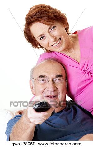 Portrait of a senior couple watching television View Large Photo Image Stock Photo - Portrait of a senior couple watching television. Fotosearch
