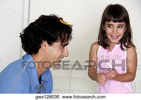 Side profile of a father and his daughter laughing View Large Photo Image Stock Image - Side profile of a father and his daughter laughing. Fotosearch