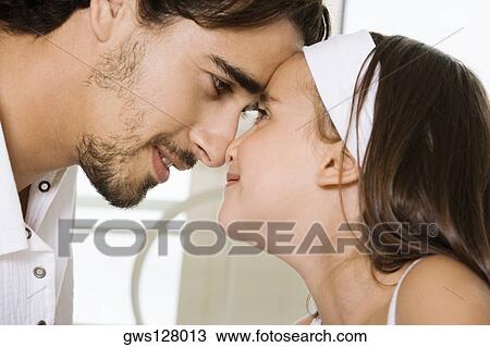 Side profile of a father looking at his daughter View Large Photo Image Stock Image - Side profile of a father looking at his daughter. Fotosearch