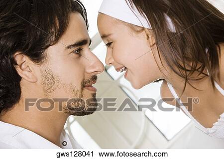 Side profile of a father looking at his daughter View Large Photo Image Stock Image - Side profile of a father looking at his daughter. Fotosearch