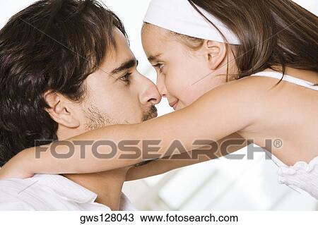Side profile of a father looking at his daughter View Large Photo Image Stock Image - Side profile of a father looking at his daughter. Fotosearch