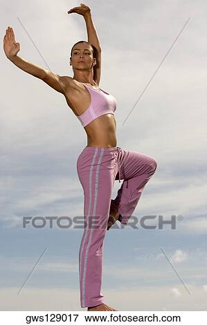 Low angle view of a mid adult woman practicing martial arts View Large Photo Image Stock Photo - Low angle view of a mid adult woman practicing martial arts. Fotosearch