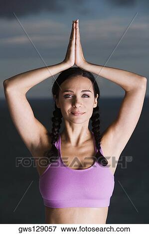 Stock Photo - Portrait of a mid adult woman performing yoga. Fotosearch