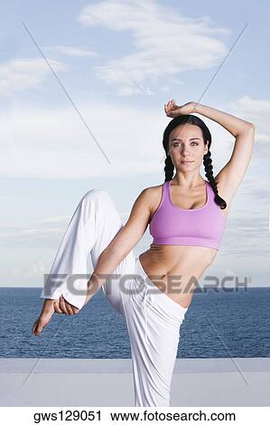 Portrait of a young woman exercising View Large Photo Image Stock Image - Portrait of a young woman exercising. Fotosearch