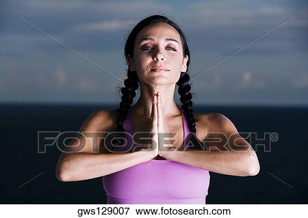 Stock Photo - Portrait of a young woman meditating. Fotosearch