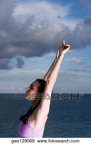Side profile of a young woman meditating View Large Photo Image Stock Image - Side profile of a young woman meditating. Fotosearch