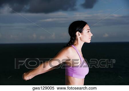 Side profile of a young woman meditating View Large Photo Image Stock Photography - Side profile of a young woman meditating. Fotosearch