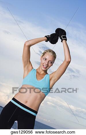 Young woman wearing boxing gloves View Large Photo Image Stock Photograph - Young woman wearing boxing gloves. Fotosearch