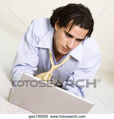 Close-up of a businessman looking at a laptop View Large Photo Image Stock Photography - Close-up of a businessman looking at a laptop. Fotosearch