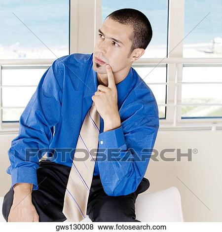 Stock Photo - Close-up of a businessman sitting on a couch. Fotosearch