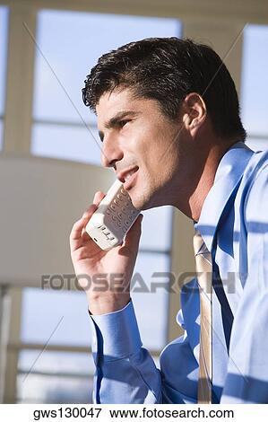 Close-up of a businessman talking on a cordless phone View Large Photo Image Stock Photo - Close-up of a businessman talking on a cordless phone. Fotosearch