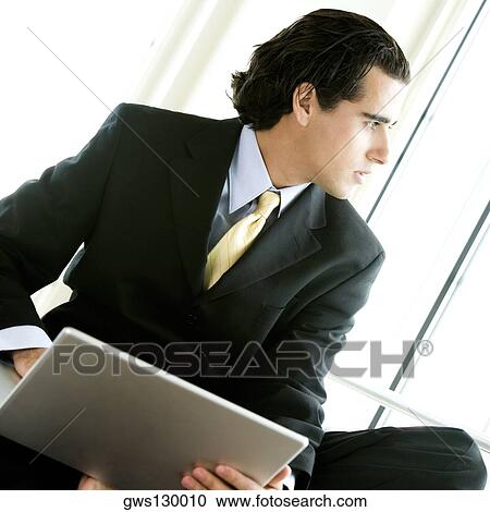 Close-up of a businessman using a laptop View Large Photo Image Stock Image - Close-up of a businessman using a laptop. Fotosearch