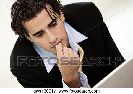Stock Photo - Close-up of a businessman with his finger on his lips. Fotosearch