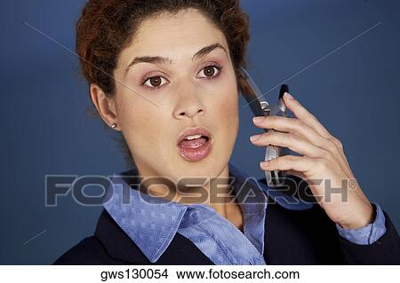 Close-up of a businesswoman talking on a mobile phone View Large Photo Image Picture - Close-up of a businesswoman talking on a mobile phone. Fotosearch