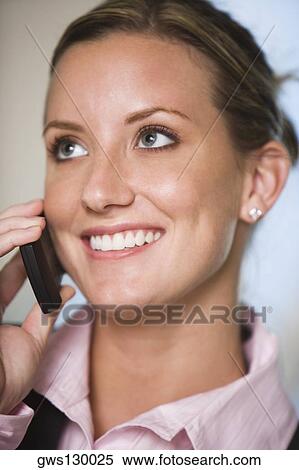Stock Photography - Close-up of a businesswoman talking on a mobile phone. Fotosearch