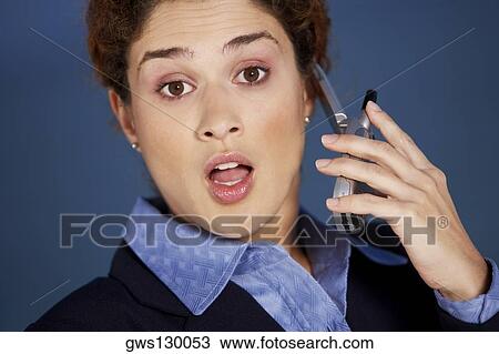 Close-up of a young woman talking on a mobile phone View Large Photo Image Stock Image - Close-up of a young woman talking on a mobile phone. Fotosearch