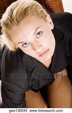 Picture - High angle view of a young woman sitting on a chair. Fotosearch