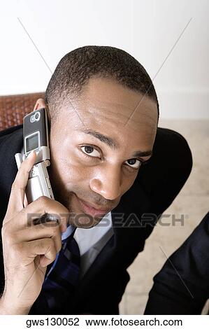 Portrait of a businessman using a mobile phone View Large Photo Image Stock Image - Portrait of a businessman using a mobile phone. Fotosearch