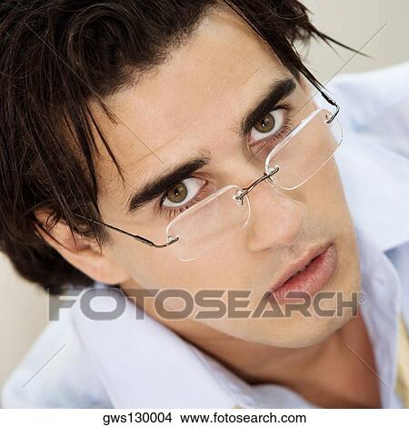 Portrait of a businessman wearing eyeglasses View Large Photo Image Picture - Portrait of a businessman wearing eyeglasses. Fotosearch