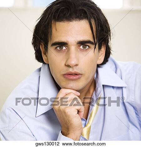 Portrait of a businessman with his hand on his chin View Large Photo Image Stock Image - Portrait of a businessman with his hand on his chin. Fotosearch