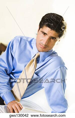 Portrait of a businessman working on a laptop View Large Photo Image Stock Image - Portrait of a businessman working on a laptop. Fotosearch