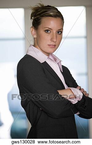 Portrait of a businesswoman standing with her arms crossed View Large Photo Image Stock Photo - Portrait of a businesswoman standing with her arms crossed. Fotosearch