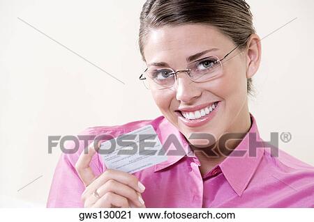 Portrait of a young woman holding a credit card View Large Photo Image Stock Image - Portrait of a young woman holding a credit card. Fotosearch