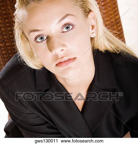 Stock Image - Portrait of a young woman looking up. Fotosearch