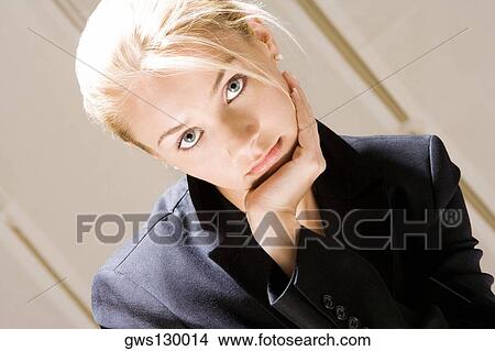 Portrait of a young woman with her hand on her chin View Large Photo Image Picture - Portrait of a young woman with her hand on her chin. Fotosearch