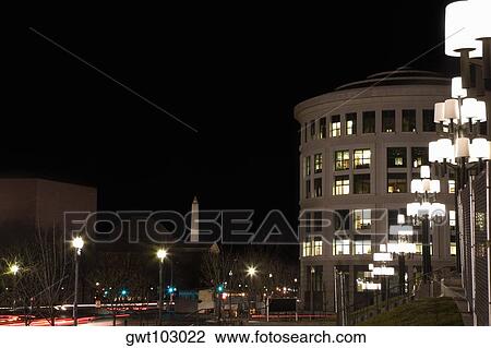 Stock Image - Buildings in a city lit up at night, Washington DC, USA. Fotosearch