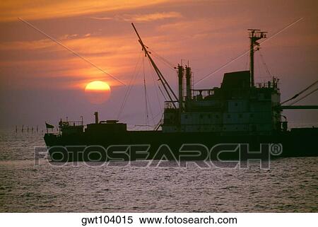Freighter at sunset in Ho Chi Minh City (formerly Saigon) Vietnam View Large Photo Image Stock Photography - Freighter at sunset in Ho Chi Minh City (formerly Saigon) Vietnam. Fotosearch