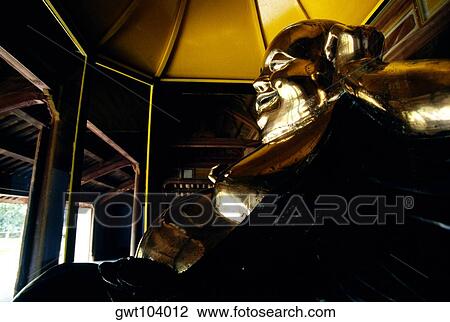 Stock Image - Golden Buddha, Thien Mu Pagoda, Hue, Vietnam. Fotosearch