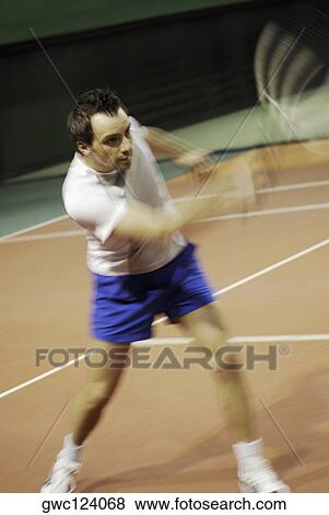 Close-up of a mid adult man playing tennis View Large Photo Image Stock Photo - Close-up of a mid adult man playing tennis. Fotosearch