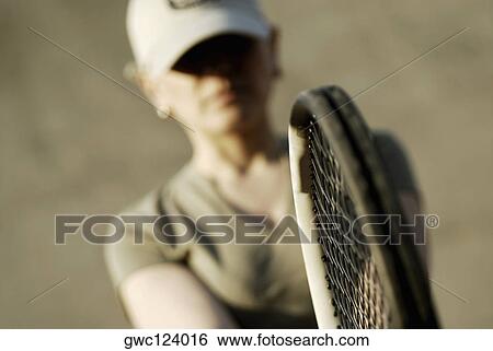 Close-up of a mid adult woman holding a tennis racket View Large Photo Image Stock Photograph - Close-up of a mid adult woman holding a tennis racket. Fotosearch