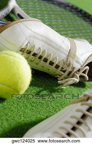 Close-up of a pair of sports shoes with a tennis racket and a tennis ball View Large Photo Image Stock Photography - Close-up of a pair of sports shoes with a tennis racket and a tennis ball. Fotosearch