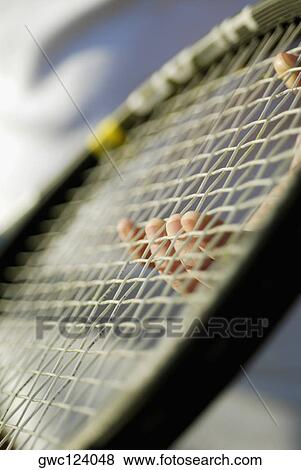Close-up of a person's finger holding a tennis racket View Large Photo Image Stock Photo - Close-up of a person's finger holding a tennis racket. Fotosearch