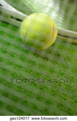 Stock Photo - Close-up of a tennis ball and two tennis rackets. Fotosearch