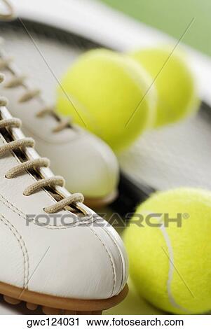 Close-up of a tennis shoe with tennis balls and a racket View Large Photo Image Stock Image - Close-up of a tennis shoe with tennis balls and a racket. Fotosearch