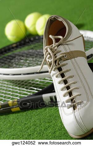Close-up of a tennis shoe with tennis rackets and tennis balls View Large Photo Image Stock Image - Close-up of a tennis shoe with tennis rackets and tennis balls. Fotosearch
