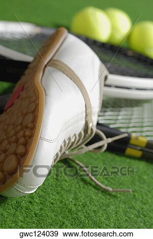 Close-up of a tennis shoe with tennis rackets and tennis balls View Large Photo Image Stock Photo - Close-up of a tennis shoe with tennis rackets and tennis balls. Fotosearch