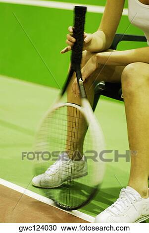 Close-up of a woman holding a tennis racket View Large Photo Image Stock Image - Close-up of a woman holding a tennis racket. Fotosearch