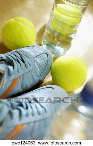 Close-up of two tennis balls with a pair of tennis shoe and a water bottle View Large Photo Image Stock Image - Close-up of two tennis balls with a pair of tennis shoe and a water bottle. Fotosearch