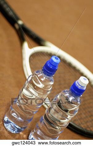 High angle view of two water bottles with a tennis racket View Large Photo Image Stock Image - High angle view of two water bottles with a tennis racket. Fotosearch